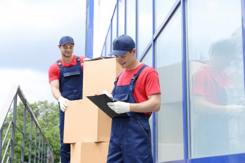 Packing and loading belongings into a moving truck for a Holland Park relocation