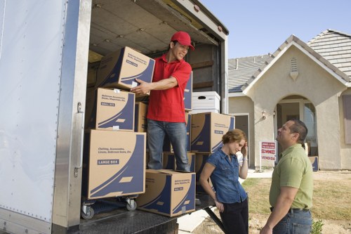 Professional movers handling furniture in a Holland Park flat