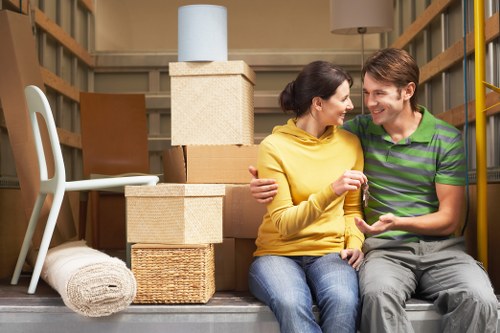 Careful furniture wrapping and box labelling during a West London move